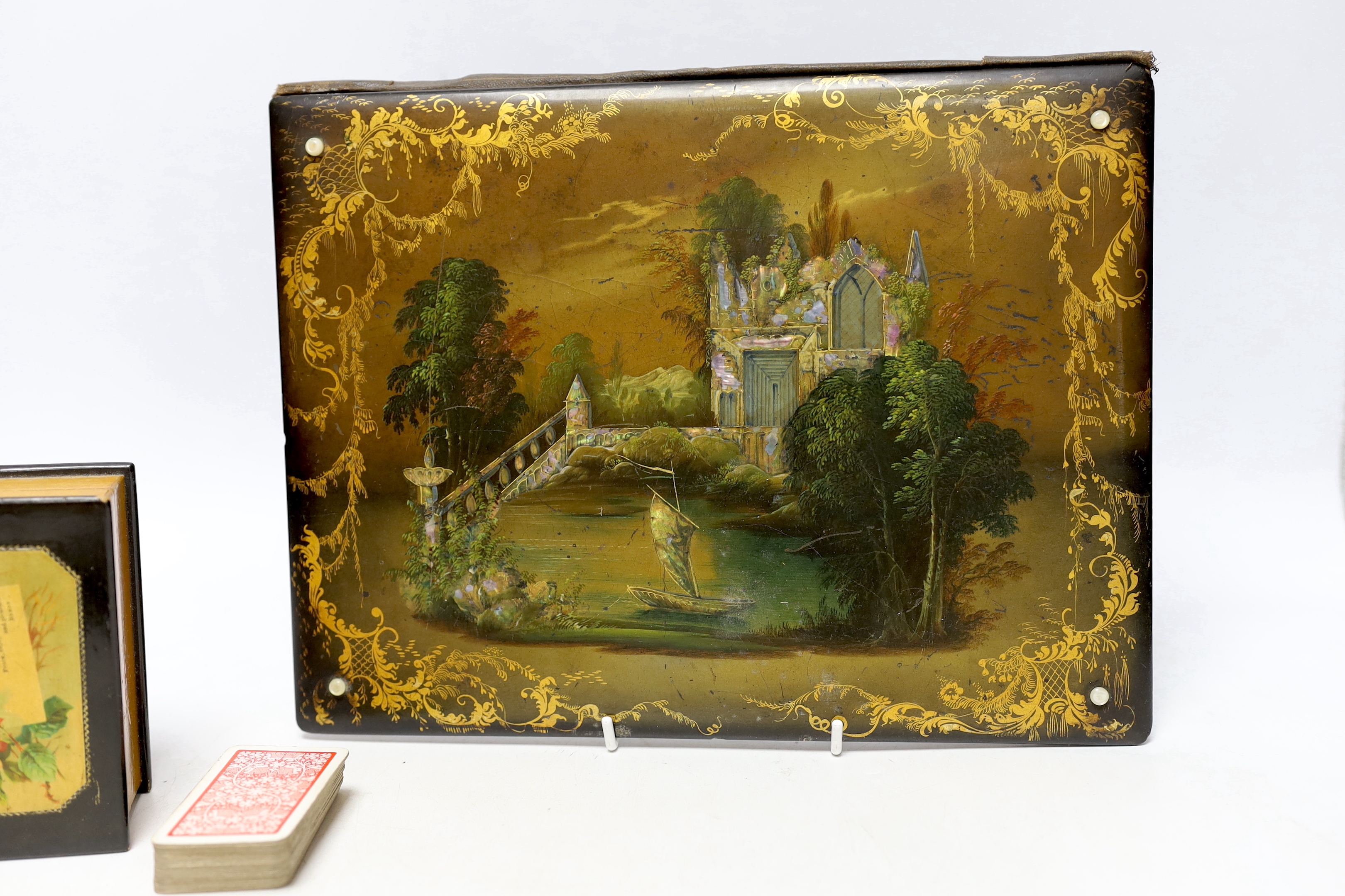 A Victorian papier maché blotter pad, and stationery box and two ebonised treen boxes